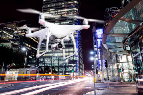Hovering drone taking pictures of city of London at night