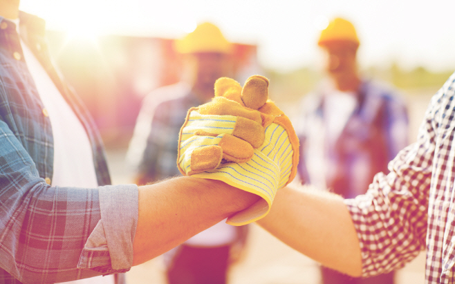 close up of builders hands making handshake