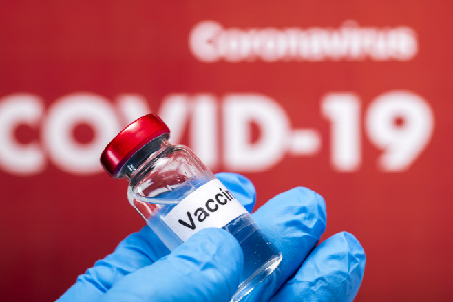 Covid-19 vaccine on hand with latex glove
