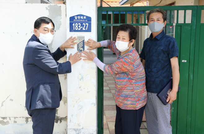 주낙영 경주시장이 국가유공자의 집에 명패를 달아드리고 있다