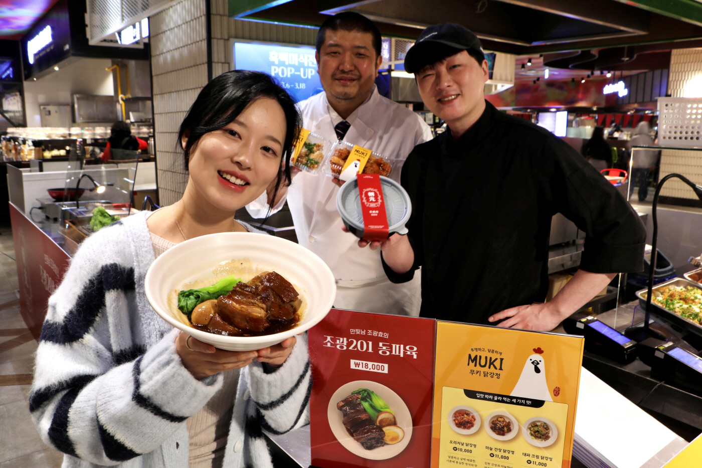 1. [롯데백화점] 서울시 송파구 신천동에 위치한 잠실점 지하 1층에서 진행 중인 흑백미식전 팝업행사장 앞에서 모델들이 상품을 들고 있다.