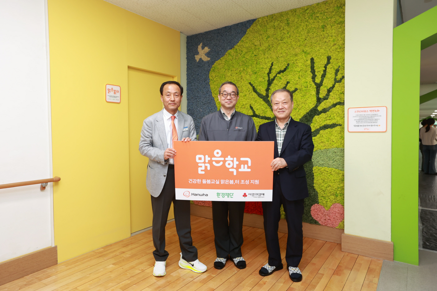 사진2_한화에어로스페이스_정인섭_사장,_환경재단_최열_이사장,_진교초등학교_정희철_교장이_맑은봄,터_앞에서_기념_촬영을