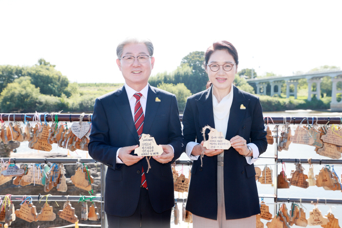 오태완 의령군수(왼쪽)와 부인 배민주 여사가 2일 솥바위 일원에 마련된 리치 소원나무 앞에서 소원패를 들어 보이고 있다. 오 군수는 소원패에 ‘만사형통(萬事亨通)’을 적었다